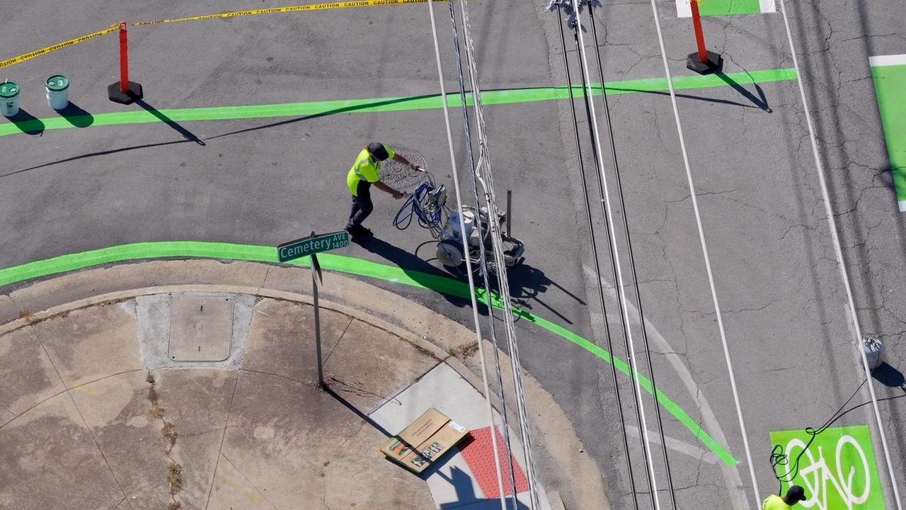 Crews painting road lines, seen from above